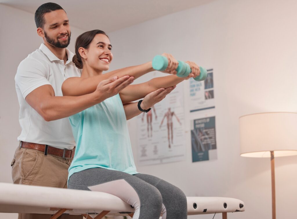 Physical therapy, dumbbell and physiotherapist helping woman for muscle, fitness and body healthcar